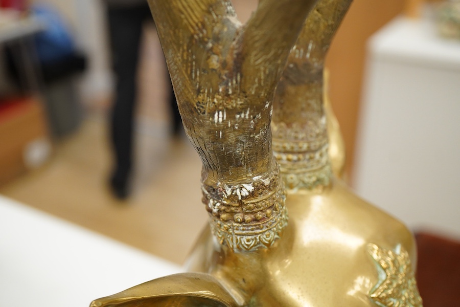 A pair of modern Chinese polished bronze 'Feng Shui' models of antlered recumbent deer with decorated bodies, height 66cm